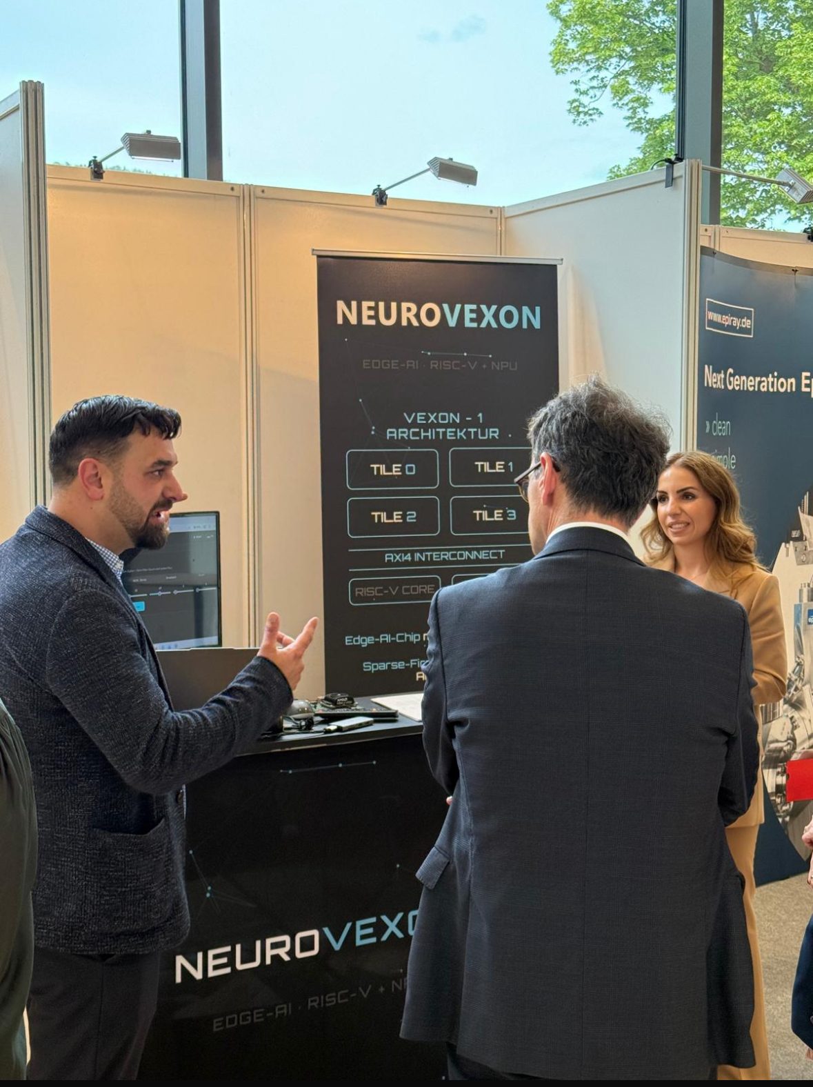 In conversation with visitors about the Vexon-1 architecture.
